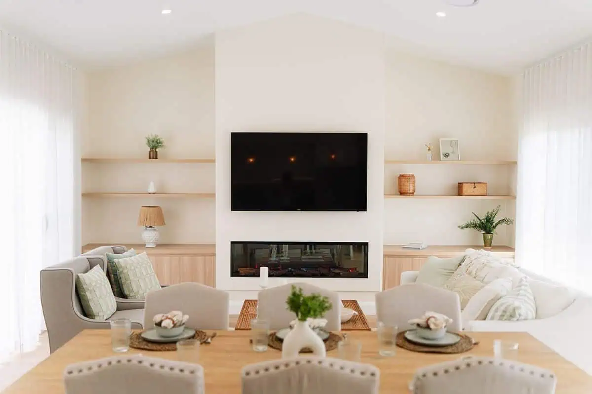 Bright, modern living room with fireplace and wall-mounted TV.